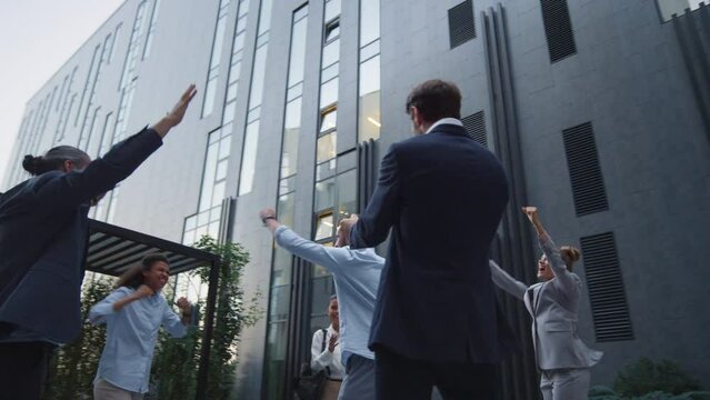 Happy team appreciate employee outside office building. Best worker recognition.