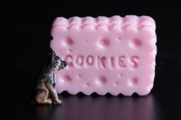 miniature figurine of a dog with a giant cookie