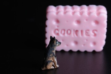 miniature figurine of a dog with a giant cookie