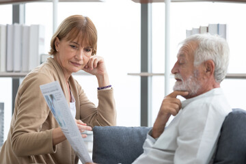 senior couple reading a newspaper in free time