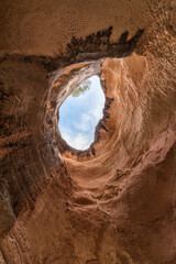 An ancient cave. Natural window made of stone. eroded cave