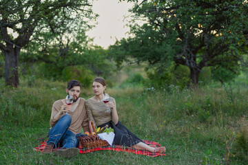 couple drinking red wine in nature