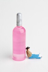 miniature figurine of a man sitting with a huge bottle of wine