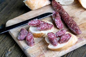 sliced pieces of sausage from meat are lying on a cutting board