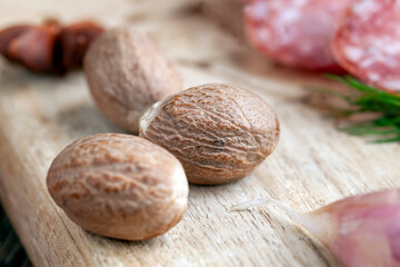 a whole nutmeg on a wooden board