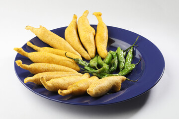 Crispy Green Chilli Pakora or Mirchi Bajji, served with tomato ketchup  Its a popular tea time snack from India especially in Monsoon