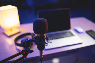 Microphone in home studio for recording and laptop using recording software to make music...