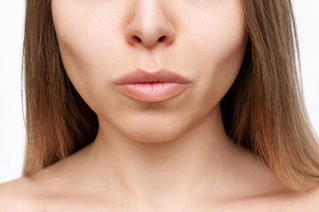 Cropped shot of a young woman's lower part of the face with clear highlighted cheekbones isolated...