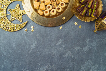 Ramadan kareem holiday background with dried dates, Ramadan sweets and decorations. Top view, flat lay