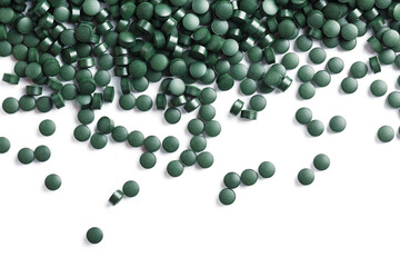Vegetarian vitamins from Spirulina are scattered on a white background