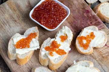 red salmon or trout caviar with white baguette and butter