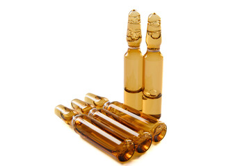 Three dark glass ampoules with medicine, isolated on a white background.