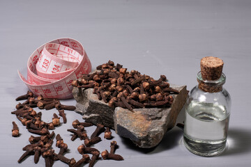 clove grains and cinnamon sticks, a bottle of clove oil