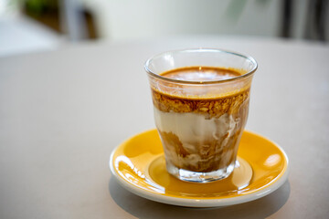 cup of milk coffee on white table