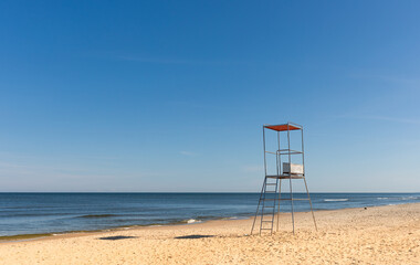 Lifeguard chair on empty sandy beach Baltic Sea Poland