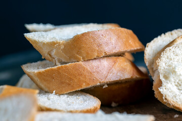 wheat baguette cut into pieces on a cutting board