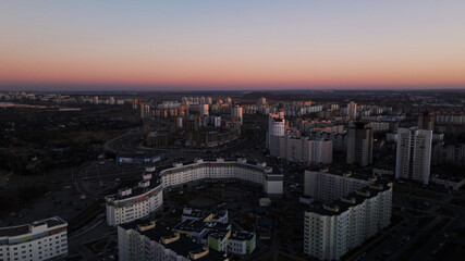 Naklejka na ściany i meble City block. Modern multi-storey buildings. Flying at dusk at sunset. Aerial photography.