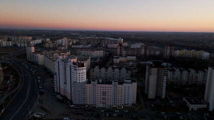 Fototapeta premium City block. Modern multi-storey buildings. Flying at dusk at sunset. Aerial photography.
