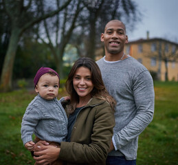 Fototapeta premium Hes little but hes brought the most joy into our lives. Portrait of a mother and a father bonding with their little son outdoors.
