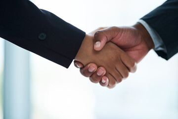 Thank you for your service. Cropped shot of two unrecognizable businesspeople shaking hands in an...