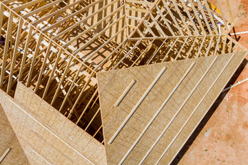 Top view of roofing construction with wooden roof frame built new house