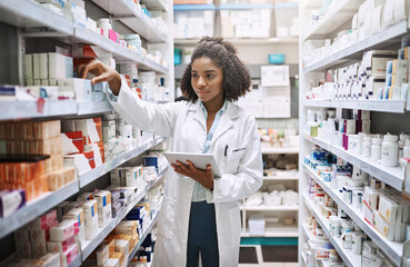 Never fear, your pharmacist is here. Cropped shot of an attractive young female pharmacist working in a pharmacy. - obrazy, fototapety, plakaty