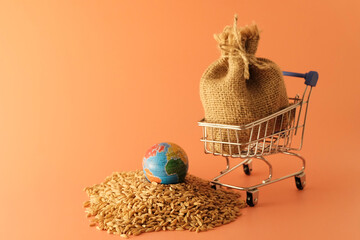 A bag of wheat in a grocery cart, spilled, near the globe, earth globe. Concept - world food...