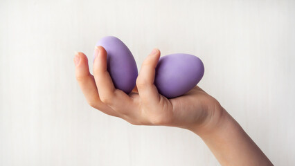 The girl's hands hold an Easter egg, close-up. Easter.