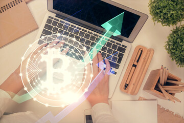 Double exposure of woman hands working on computer and blockchain theme hologram drawing. Top View. bitcoin cryptocurrency concept.