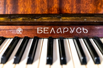 Macro closeup of soviet union vintage retro symbol and sign for Belorussia or Belarus in cyrillic on piano with keys from old communist country - obrazy, fototapety, plakaty