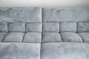 Living room interior with closeup abstract front view of futon couch gray sofa sofabed with...