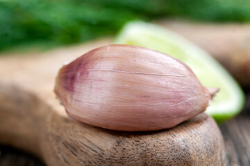 garlic cloves divided into several parts on a cutting board