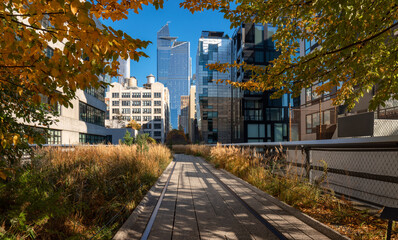 New York panoramic view of The High Line promenade . Elevated greenway in Autumn with Hudson yards skyscrapers. Chelsea, Manhattan