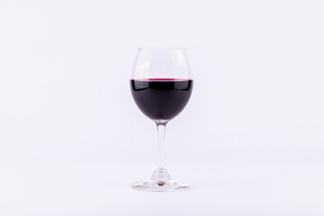 Red wine in glasses on white background.