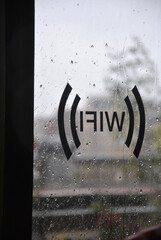 wifi inscription on the window with raindrops amsterdam