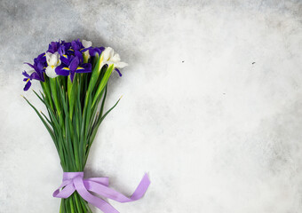 bouquet of lilac and white irises on a grey background. Horizontal view.