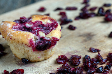wheat pastries with red cherry strawberry filling on a board, dried cranberries dried in sweet syrup are lying around the baking