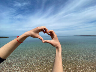 heart from hands on the background of the sea