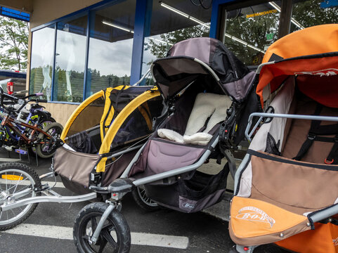 Woodinville, WA USA - circa June 2021: Angled view of gently used baby strollers for sale at a Play It Again Sports store