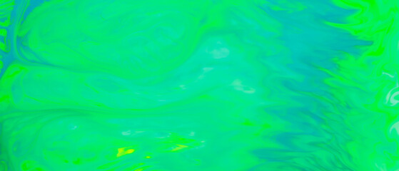 Fluid art background in green color. Green-turquoise stains on liquid. Creative background with blurred paints. Background for an eco-friendly concept