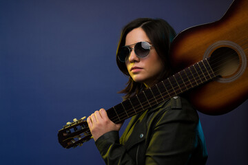 Artistic musician holding a guitar