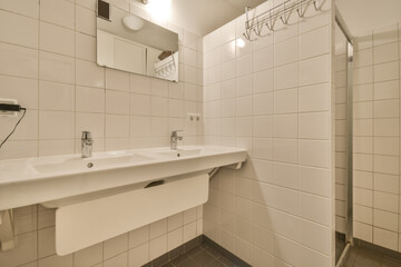 Tiled bathroom with shower and double sink in a new house