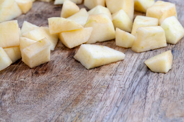 red ripe apple on a wooden chopping board