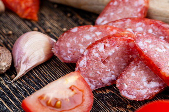 Sliced Pieces Of Sausage From Meat Are Lying On A Cutting Board