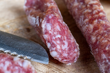 sliced pieces of sausage from meat are lying on a cutting board
