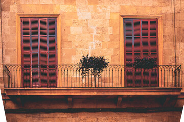 Red wood close doors on Mediterranean balcony