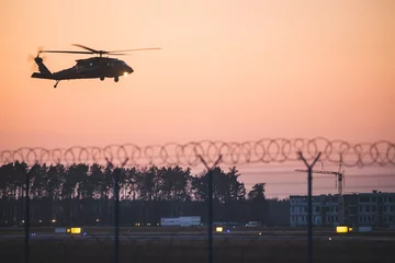 Foto op Plexiglas Black Hawk helicopter securing the visit of the president of the United States to Poland, landing at the airport in Jasionka © Pawe