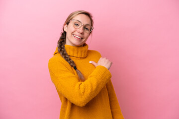 Young caucasian woman isolated on pink background proud and self-satisfied