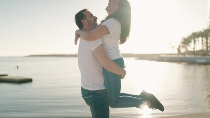 Man and woman couple hugging each other and kissing at beach