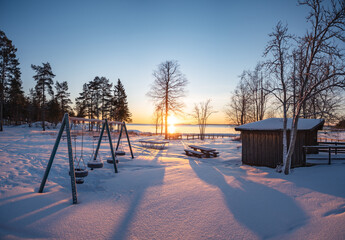Panoramic sunset through the horizon. Winter wonderland scenery in scenic golden evening light